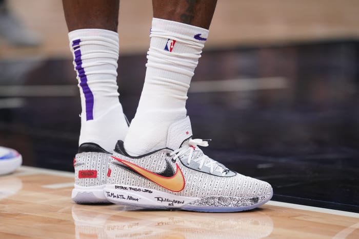 View of LeBron James' white and gold Nike shoes.